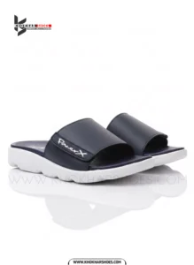 A man's feet in a pair of comfortable, navy blue and white, single-strap slides on a white background.