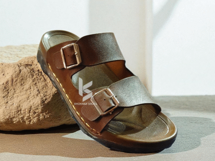 A pair of men's stylish two-strap sandals, with one in a dark brown color and the other in a deep blue-grey.