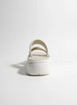 Women wearing beige cross-strap comfort sandals with cushioned sole