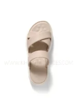 Women wearing beige cross-strap comfort sandals with cushioned sole