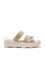 Women wearing beige cross-strap comfort sandals with cushioned sole